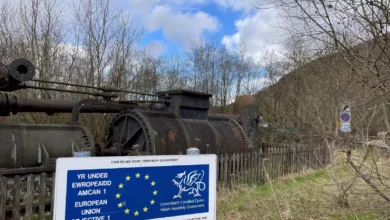 Abandoned steelworks site in Ebbw Vale with EU regeneration plaque in foreground