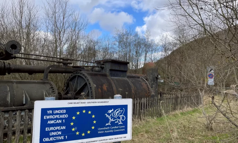 Abandoned steelworks site in Ebbw Vale with EU regeneration plaque in foreground