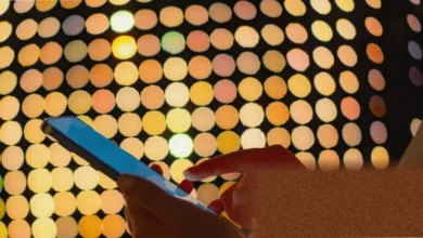 A smartphone displays a passkey login prompt with a fingerprint scan option