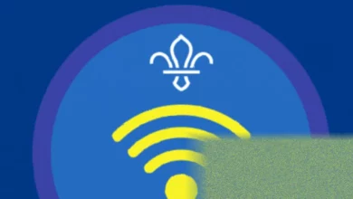 Teenage Explorer Scouts working on digital communication badges using tablets and laptops