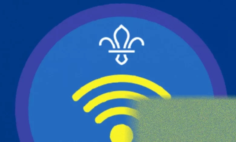 Teenage Explorer Scouts working on digital communication badges using tablets and laptops