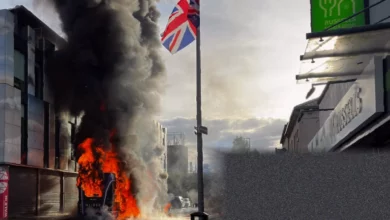 Burnt-out vehicles and smoke rising over Belfast streets after far-right disorder
