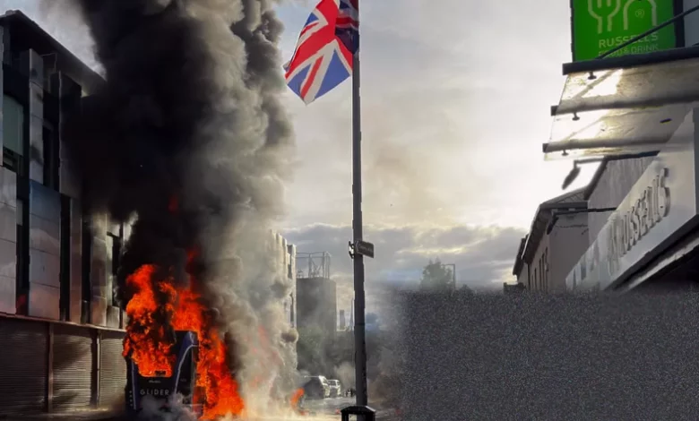 Burnt-out vehicles and smoke rising over Belfast streets after far-right disorder