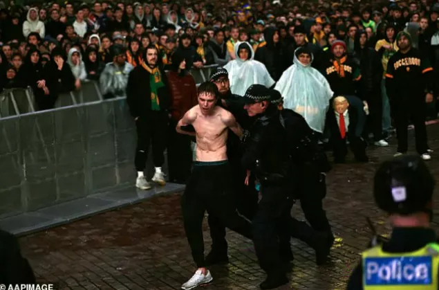 Stewards attempting to extinguish burning flares left on the ground at the live event