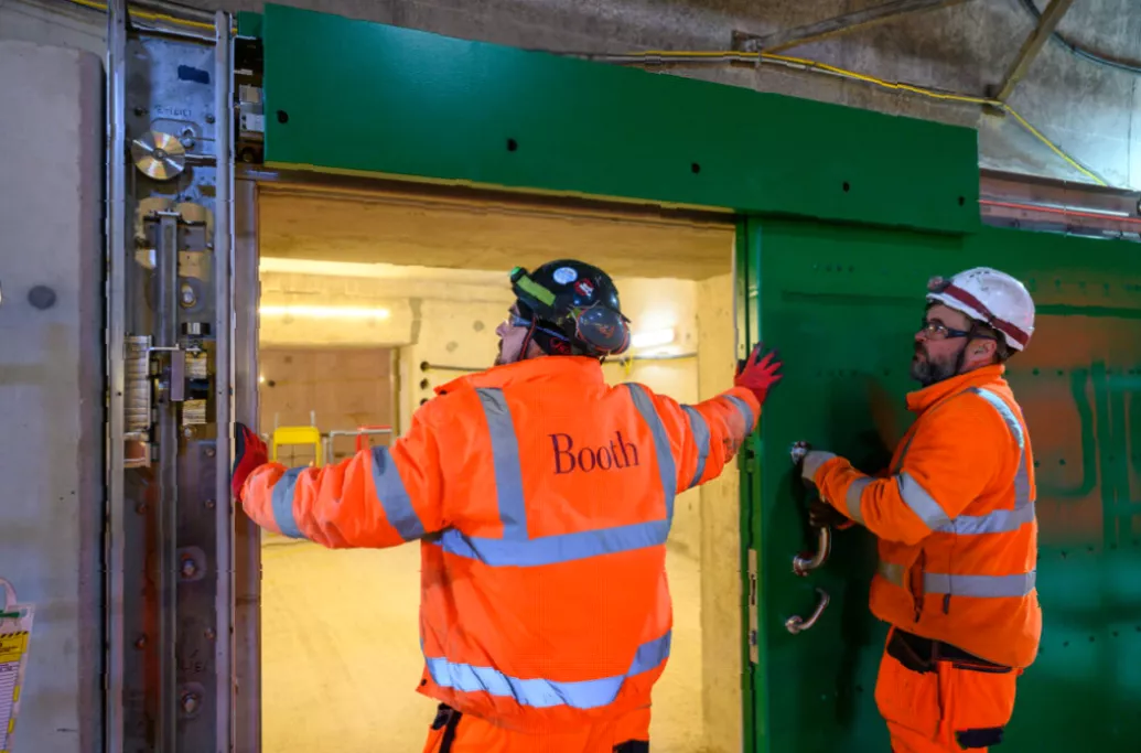 Interior walkway of HS2 tunnel showing cross-passage sliding door installation