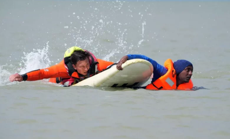Migrants being pulled from the English Channel by French rescue teams near Berck