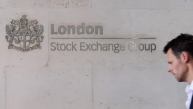 Traders on the London Stock Exchange floor observing market data screens