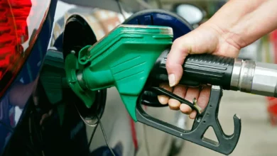 A UK petrol station forecourt displaying a price board with high petrol and diesel costs, April 2026