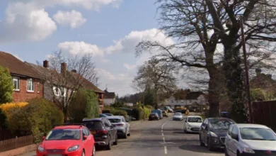 Police vehicles parked outside a terraced house on Pyrcroft Road in Chertsey