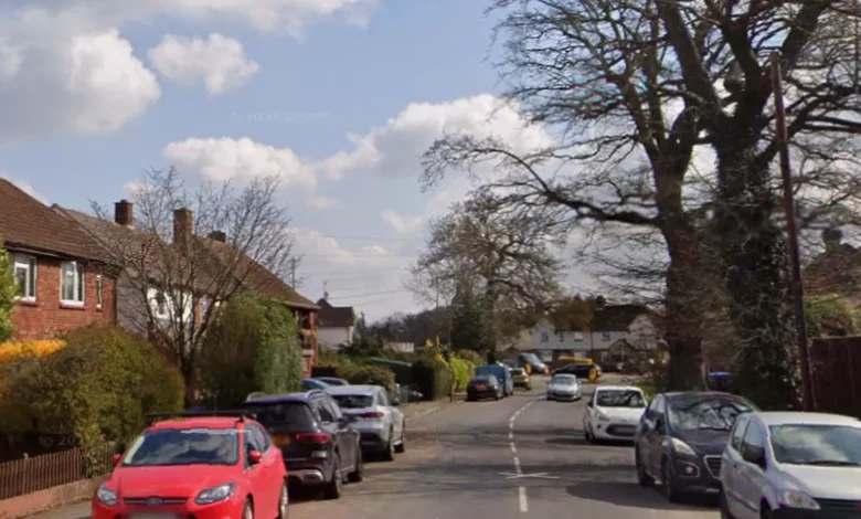Police vehicles parked outside a terraced house on Pyrcroft Road in Chertsey