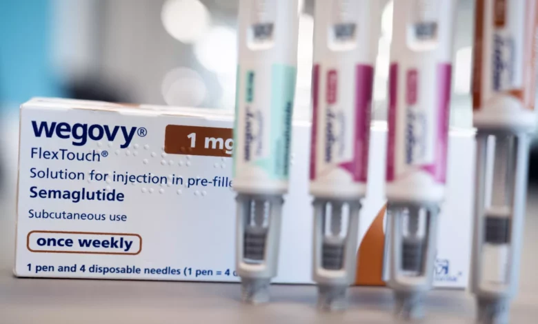 A seized batch of unlabelled injection pens and vials on a forensic evidence table.