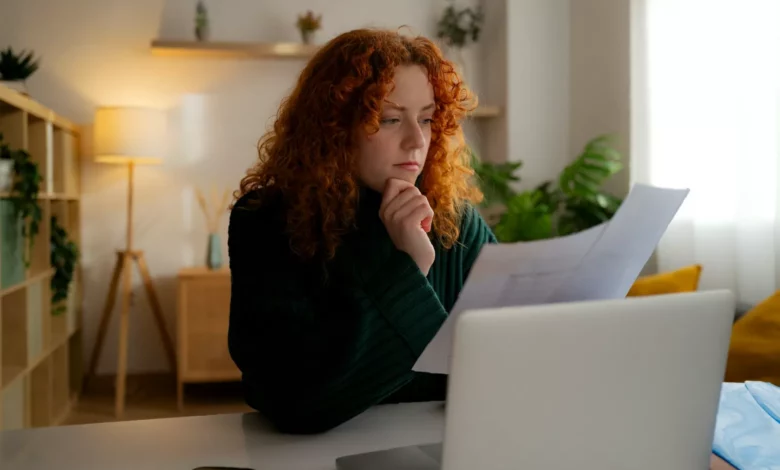Bereaved family member sitting at a desk with official tax paperwork and an HMRC envelope visible