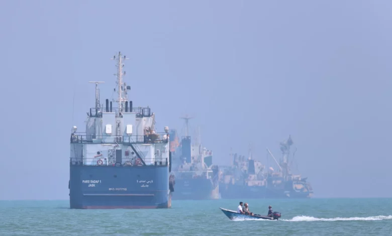 Cargo ship navigating the Strait of Hormuz under overcast skies
