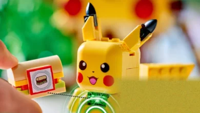 A Pikachu Lego figure built with smart bricks, sitting on a table with glowing green LEDs