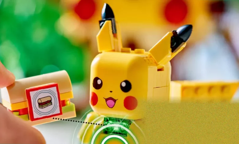 A Pikachu Lego figure built with smart bricks, sitting on a table with glowing green LEDs