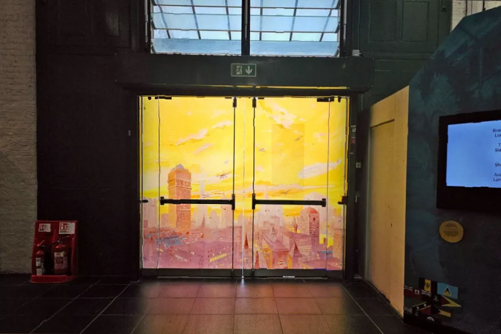 Double-height museum gallery with buses moved to sides for open entry space