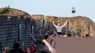 A taiko drum with red cross-rope tension on a section of the Great Wall of China.