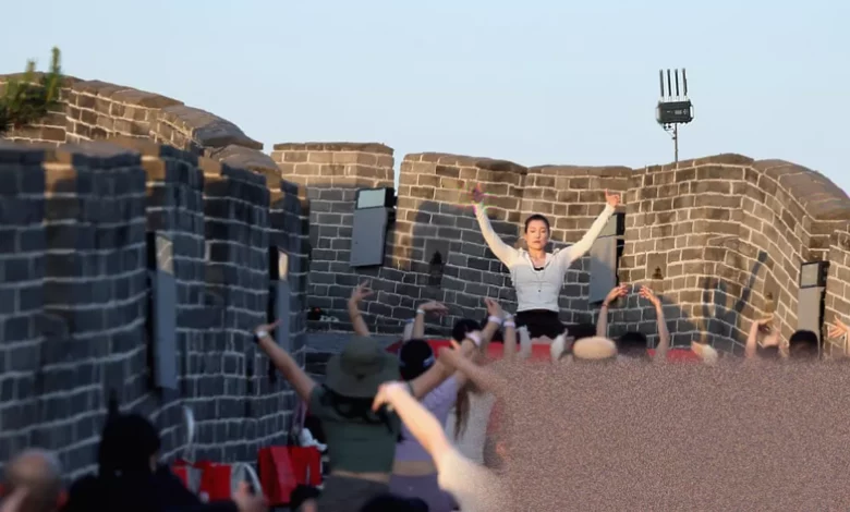A taiko drum with red cross-rope tension on a section of the Great Wall of China.