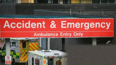 Hospital emergency department waiting room with patients seated under fluorescent lights