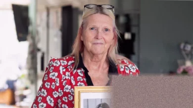 A woman holding a photograph outside a UK courthouse