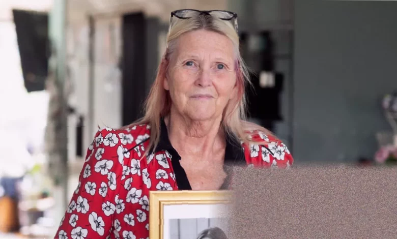 A woman holding a photograph outside a UK courthouse