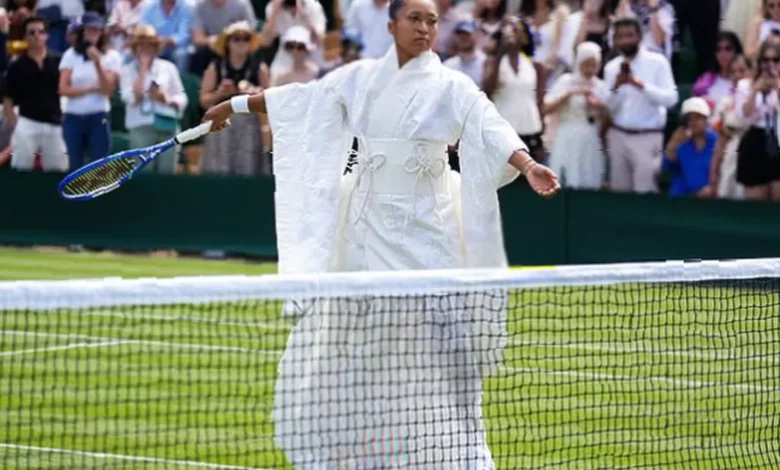 Tennis player walks onto Court 3 in layered white kimono with embroidered cranes and cherry blossoms