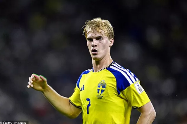 A smartphone screen displaying a football transfer news alert with a player profile image.