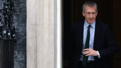 A defence secretary stands at a podium inside the Ministry of Defence building in London.