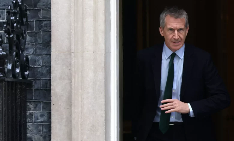 A defence secretary stands at a podium inside the Ministry of Defence building in London.