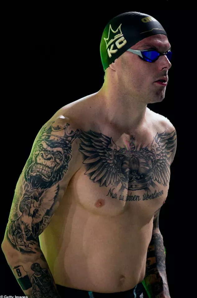 Gold medal and swimming cap placed on a pool deck