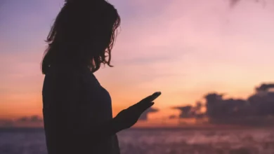 A teenager looking at a smartphone screen displaying a chatbot conversation