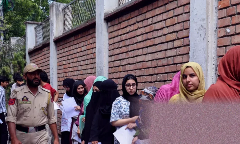 Students queue outside an Indian exam centre with airport-style security checks.