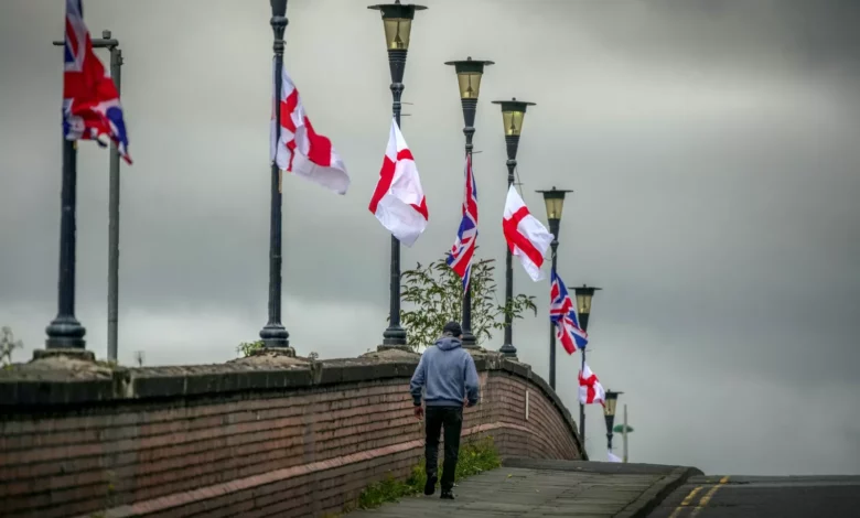 Union Jack and St George's flags tied to lampposts along an Oxfordshire street