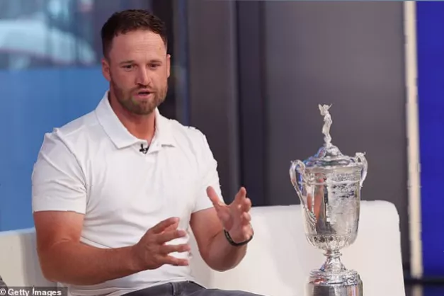 A model and golf influencer typing on a phone in a media room while defending a player online