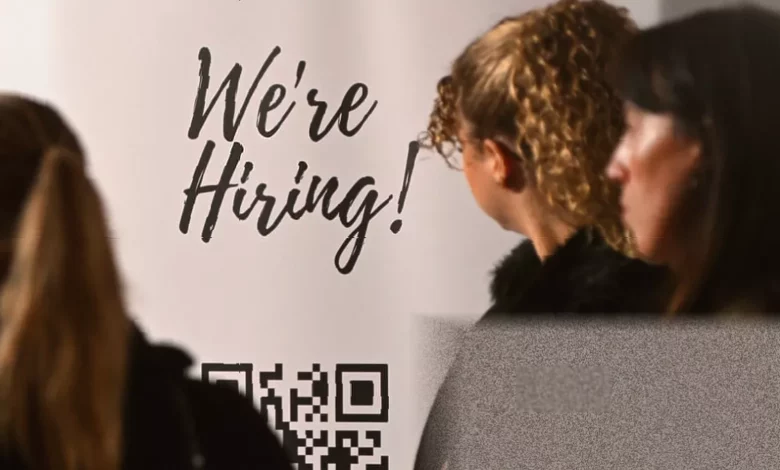 Young jobseekers queue at a recruitment event in a British city centre