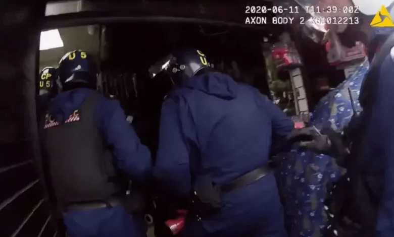 Police officers examining a safe filled with bundles of cash at a money exchange shop in East Ham
