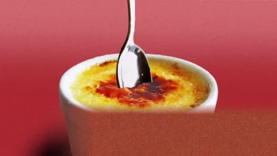 Woman refusing to share a crème brûlée in a restaurant dining room