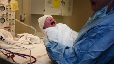 Pregnant woman being examined in a hospital triage room