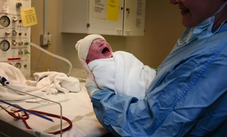 Pregnant woman being examined in a hospital triage room