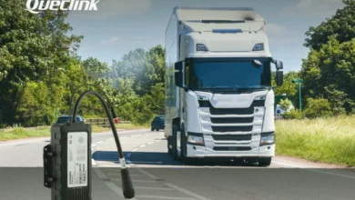 A rugged trailer tracking device attached to the underside of a heavy-duty commercial vehicle