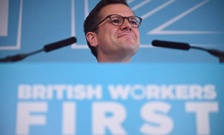 Robert Jenrick speaking at a podium during a campaign event in Makerfield