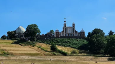 Visitors standing on the Prime Meridian line at Royal Observatory Greenwich