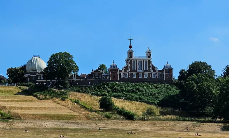 Visitors standing on the Prime Meridian line at Royal Observatory Greenwich
