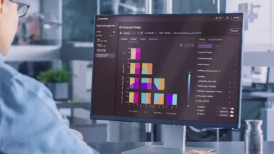 Engineers reviewing vehicle design data on digital screens in a modern office