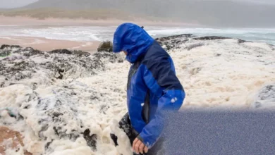 Fair Isle’s rugged coastline with stormy Atlantic waves and seafoam drifting across the land