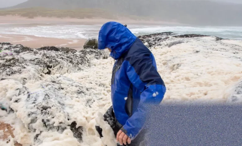 Fair Isle’s rugged coastline with stormy Atlantic waves and seafoam drifting across the land