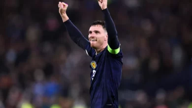 Scotland football players warming up on the pitch at Hampden Park before the Curaçao match