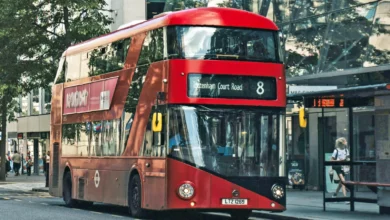 Row of stationary double-decker buses parked outside Bow Bus Garage in east London