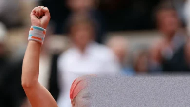 A tennis ball lying still on the red clay of Court Philippe-Chatrier at Roland Garros