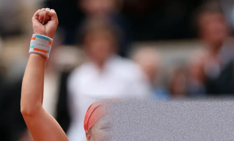 A tennis ball lying still on the red clay of Court Philippe-Chatrier at Roland Garros